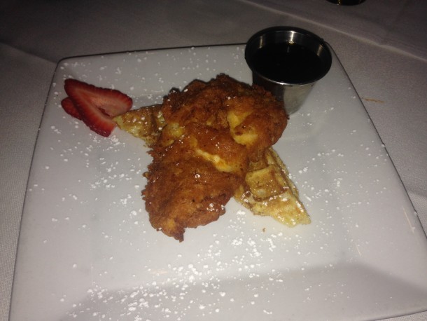 Batter Fried Chicen & Waffles with Bourbon maple syrup, powdered sugar and local strawberries.